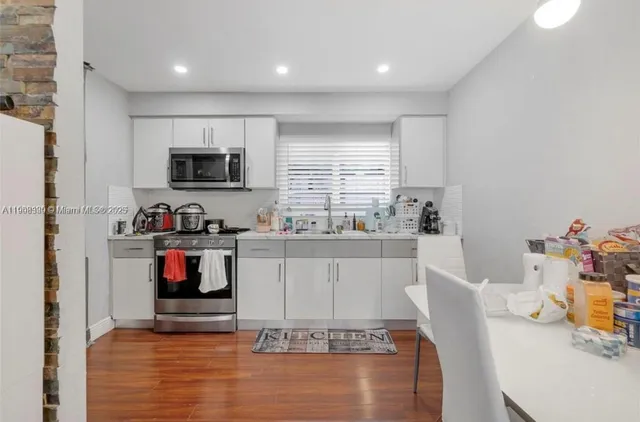 a kitchen with counter space appliances and a window