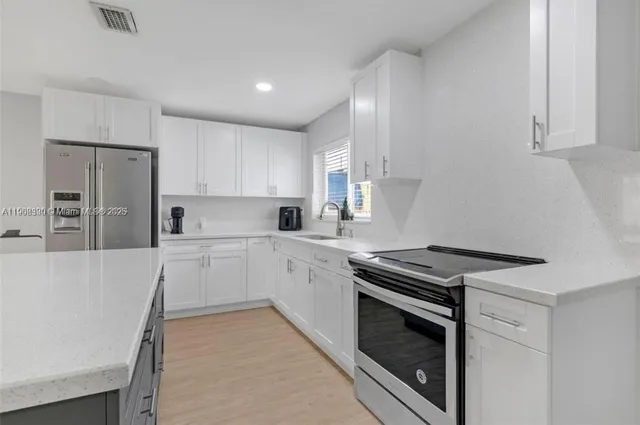 a kitchen with granite countertop cabinets and steel stainless steel appliances