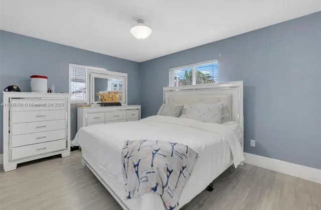 a bedroom with a large bed and a dresser