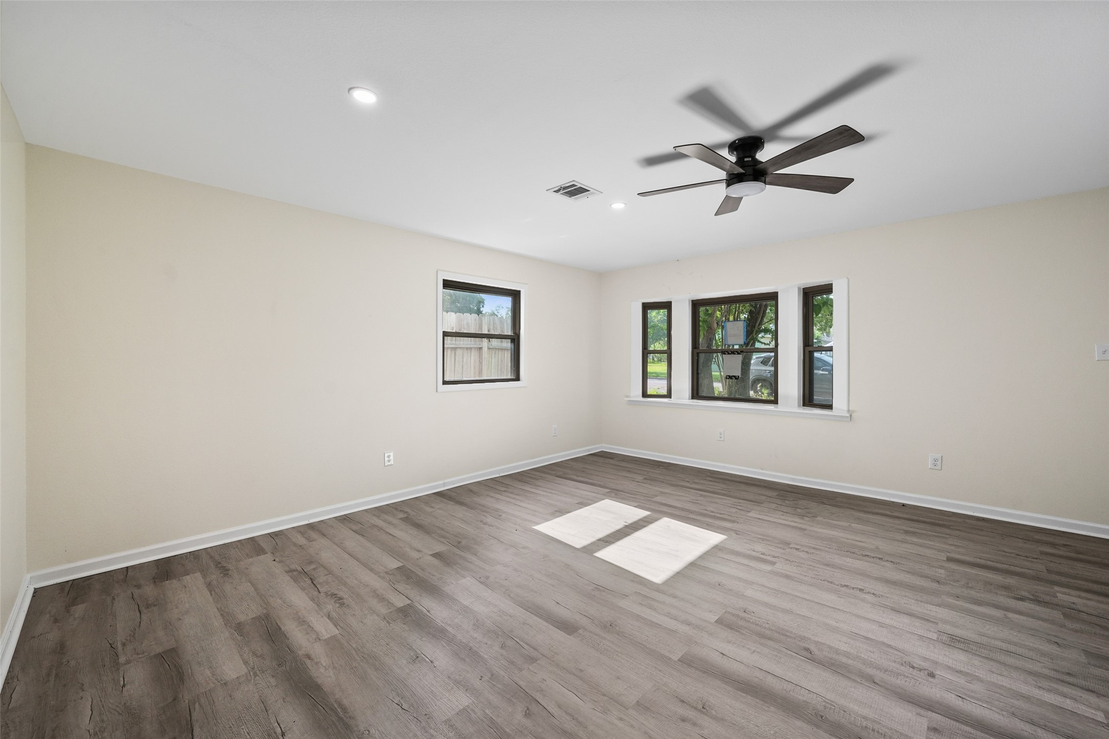 725 Lafayette Street Hempstead, TX 77445 - Photo 14 of 20 Spacious Primary bedroom with updated flooring and neutral finishes