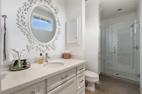 a bathroom with a toilet a sink and mirror
