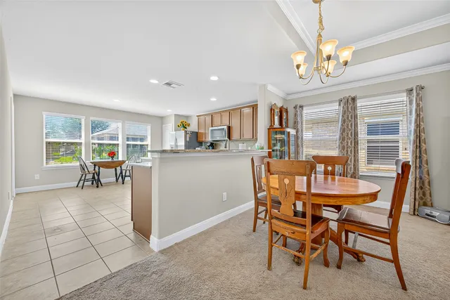 a dining room with furniture and a view of kitchen