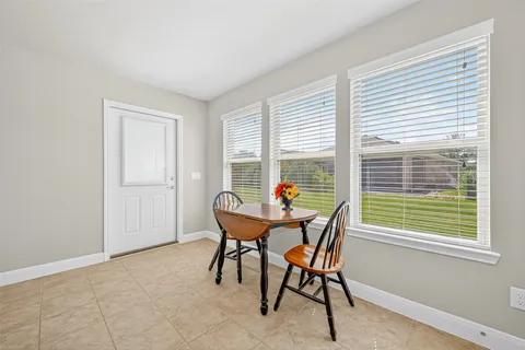 a dining room with furniture and window