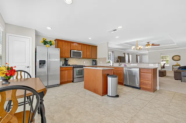 a kitchen with refrigerator a sink and a stove