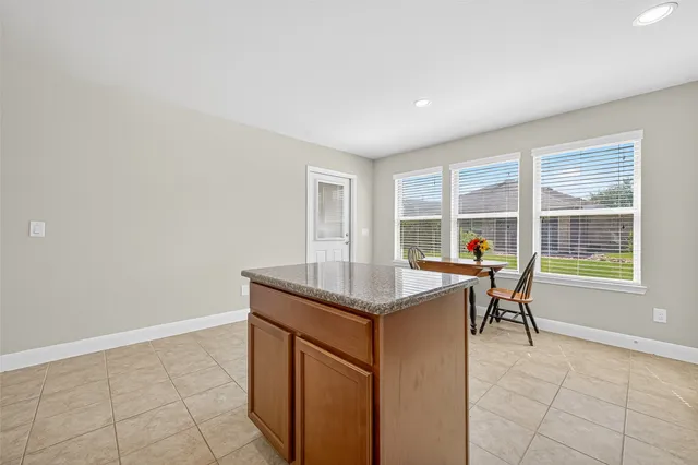 a kitchen with granite countertop cabinets and window