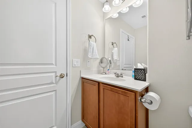 a bathroom with a sink a mirror and shower