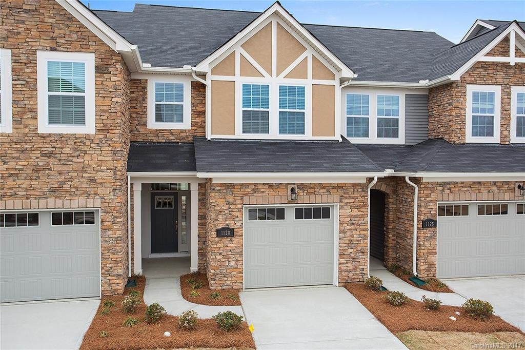 1128 Roderick Drive, Unit 70 FALKNER B Fort Mill, SC 29708 - Photo 1 of 20 a view of a brick house with large windows