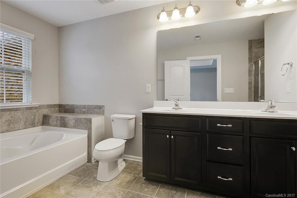1128 Roderick Drive, Unit 70 FALKNER B Fort Mill, SC 29708 - Photo 13 of 20 a bathroom with a sink vanity mirror bathtub and toilet
