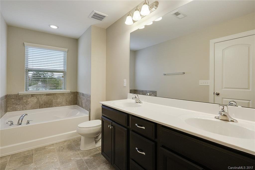 1128 Roderick Drive, Unit 70 FALKNER B Fort Mill, SC 29708 - Photo 9 of 20 a bathroom with a tub a sink double vanity and a toilet