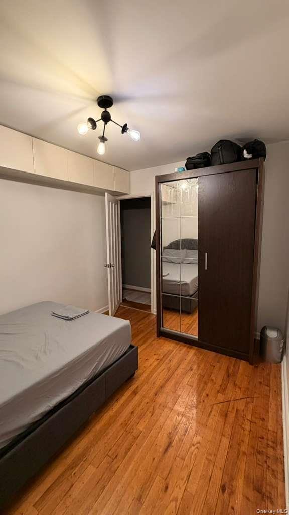 8305 98th Street, Unit 3C Queens, NY 11421 - Photo 7 of 19 a bedroom with a bed and a ceiling fan