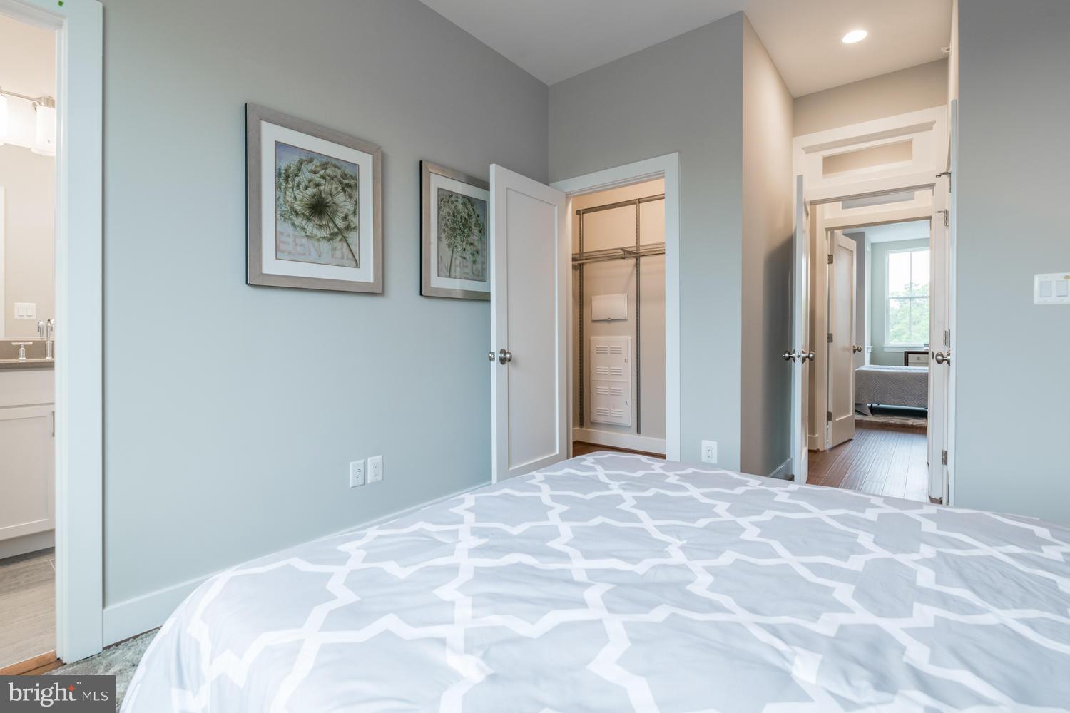 1007 Girard Street Northwest, Unit B Washington, DC 20001 - Photo 14 of 30 a bedroom with a large bed and a chandelier