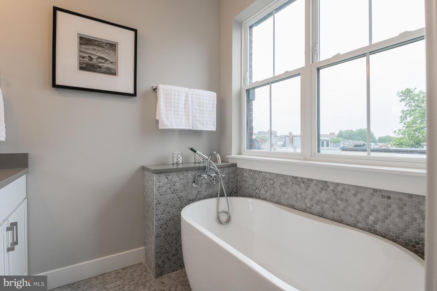 1007 Girard Street Northwest, Unit B Washington, DC 20001 - Photo 19 of 30 a bathroom with a bathtub and window