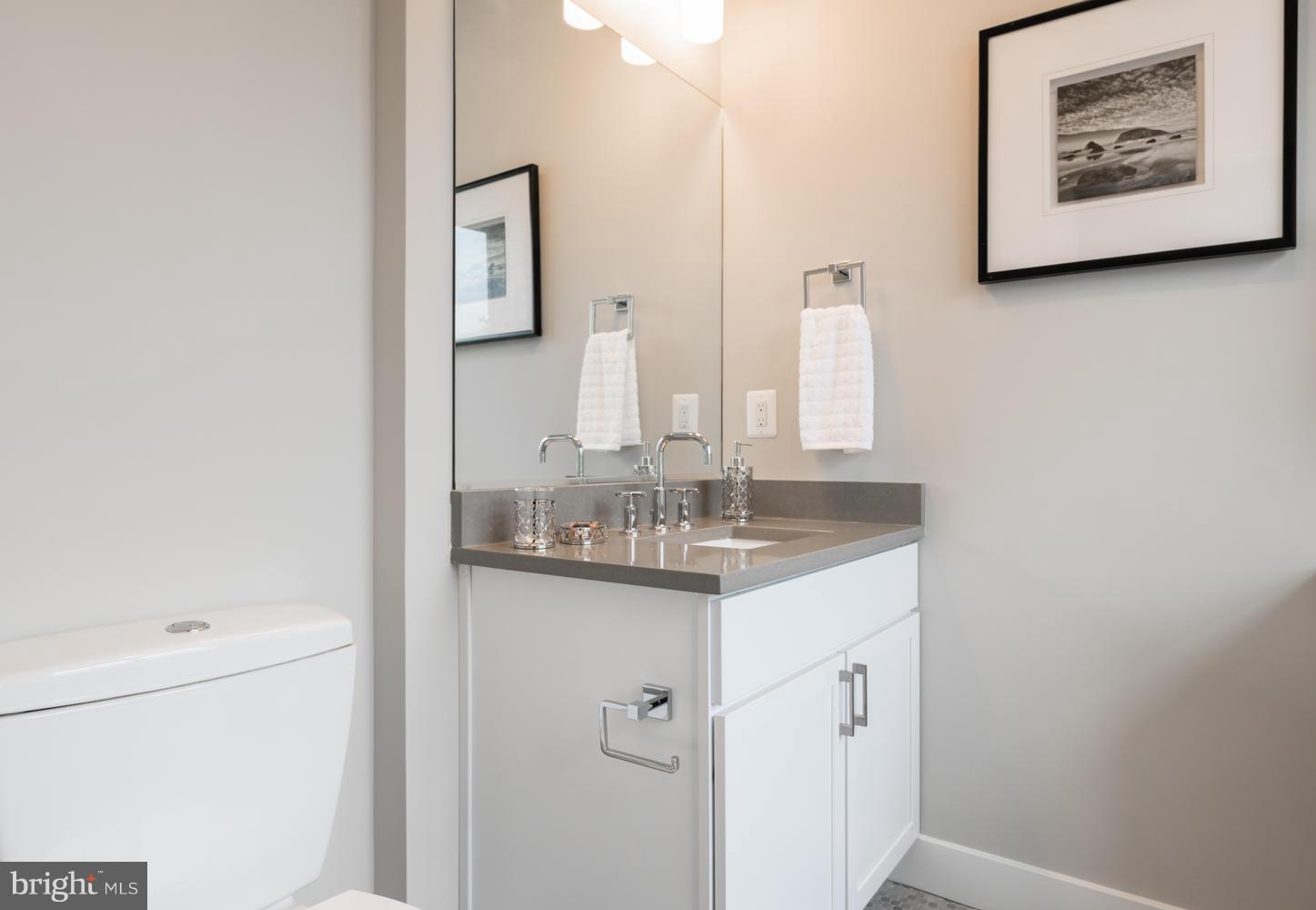 1007 Girard Street Northwest, Unit B Washington, DC 20001 - Photo 20 of 30 a bathroom with a granite countertop sink mirror and vanity