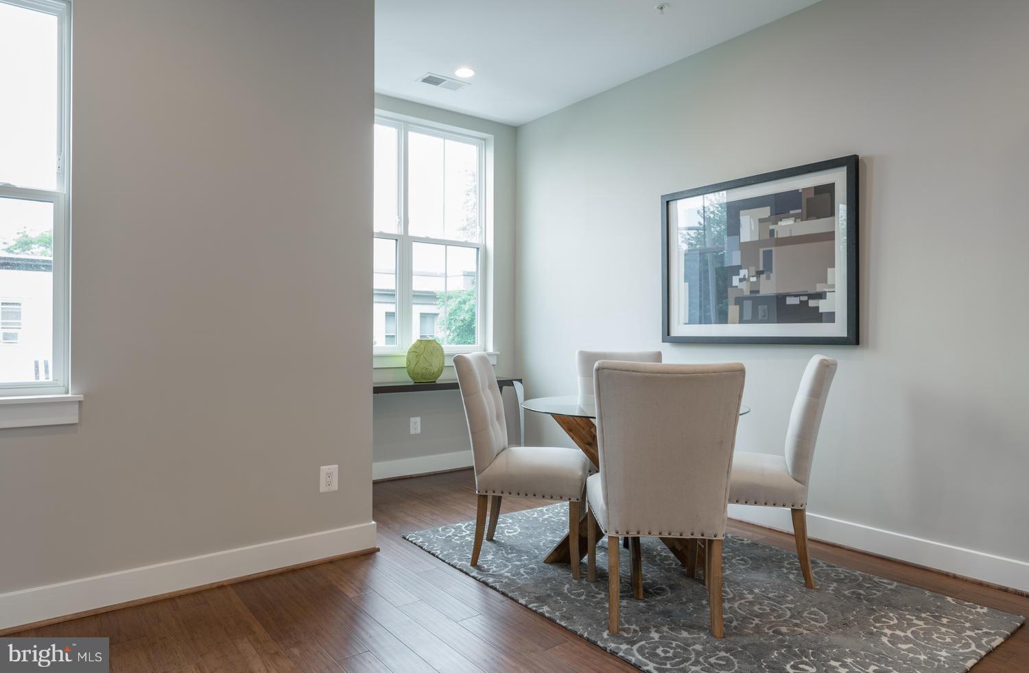 1007 Girard Street Northwest, Unit B Washington, DC 20001 - Photo 4 of 30 a view of a dining room with furniture window and wooden floor