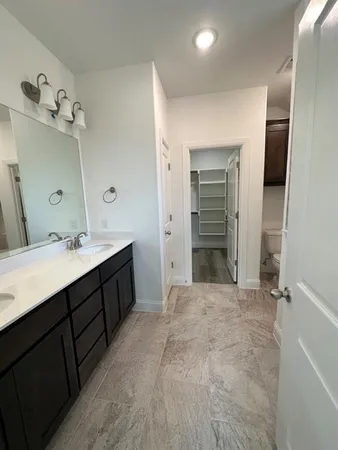 a bathroom with a double vanity sink and a mirror