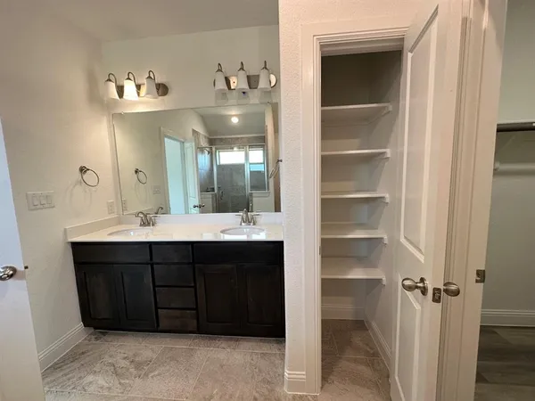 a bathroom with a sink vanity and a mirror