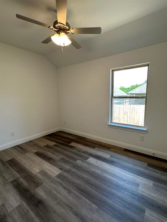 418 South 2nd Street Krum, TX 76249 - Photo 4 of 17 wooden floor in an empty room with a window