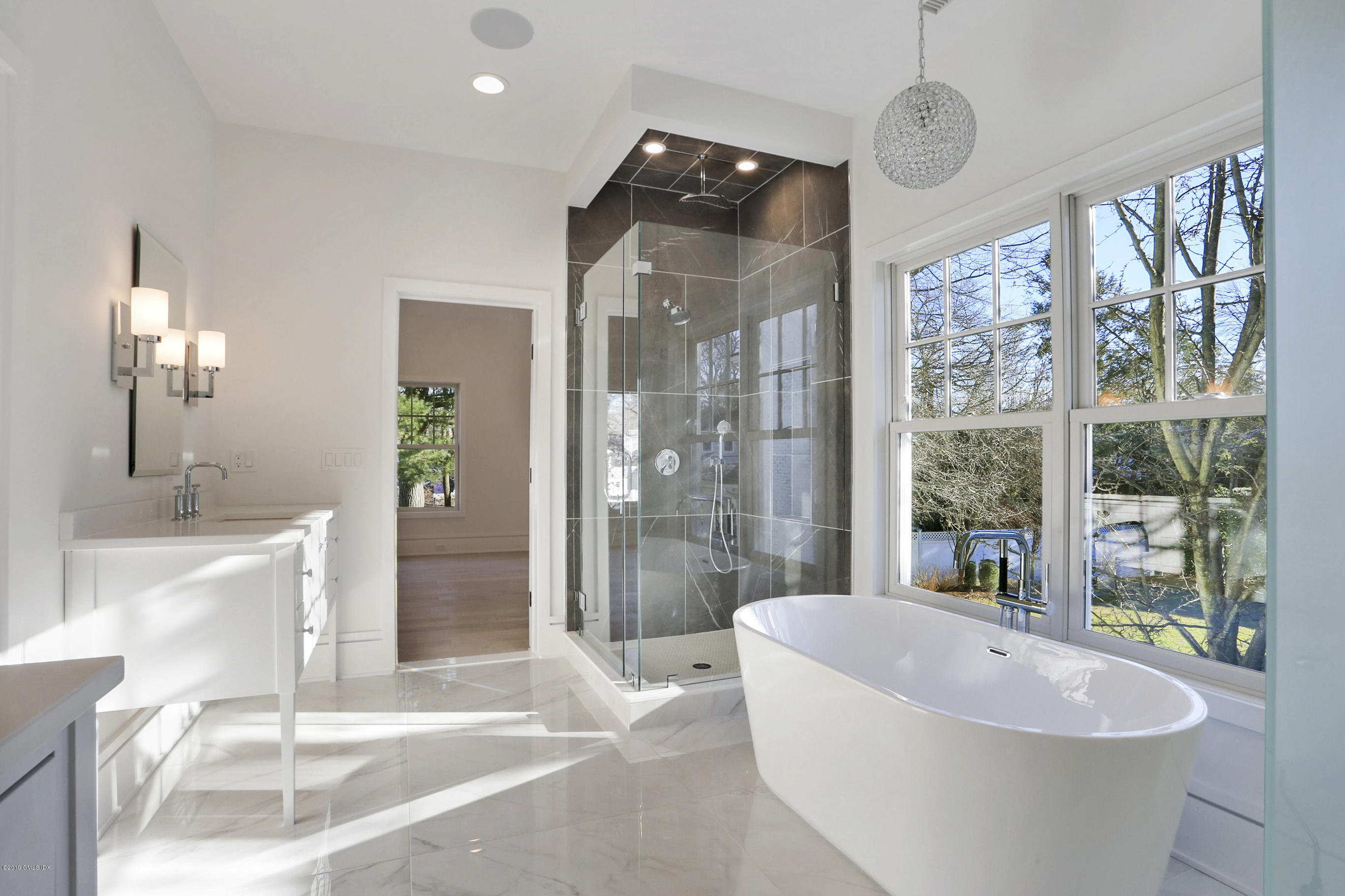 84 Circle Drive Greenwich, CT 06830 - Photo 15 of 25 a spacious bathroom with a tub sink and glass door