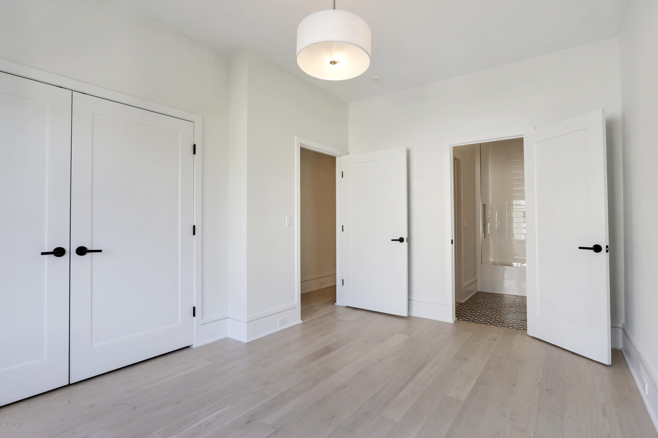84 Circle Drive Greenwich, CT 06830 - Photo 17 of 25 a view of a room with an empty space and wooden floor