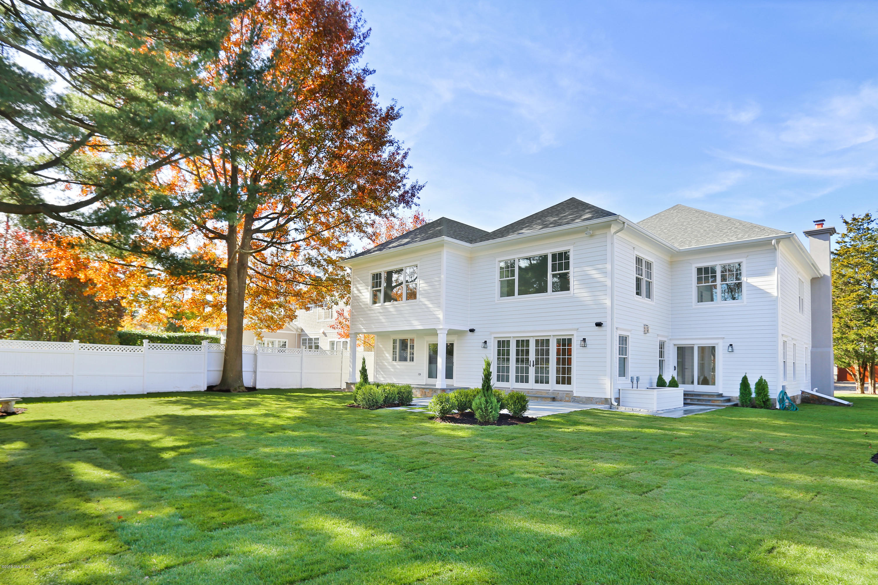 84 Circle Drive Greenwich, CT 06830 - Photo 18 of 25 a front view of a house with a garden