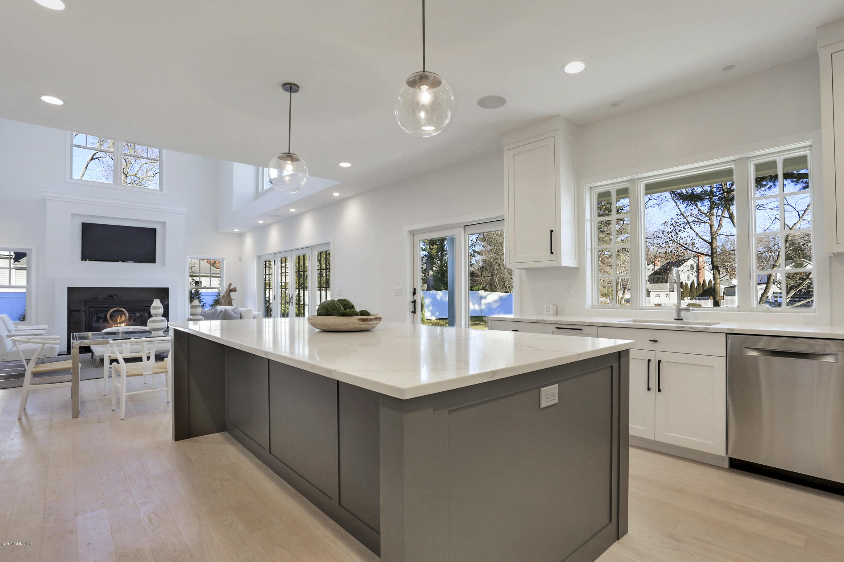 84 Circle Drive Greenwich, CT 06830 - Photo 7 of 25 a large kitchen with kitchen island a sink a center island and windows