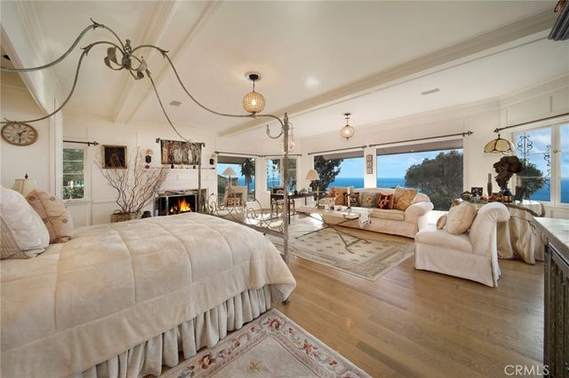 a living room with furniture a fireplace and wooden floor