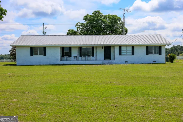 a front view of house with yard and trees