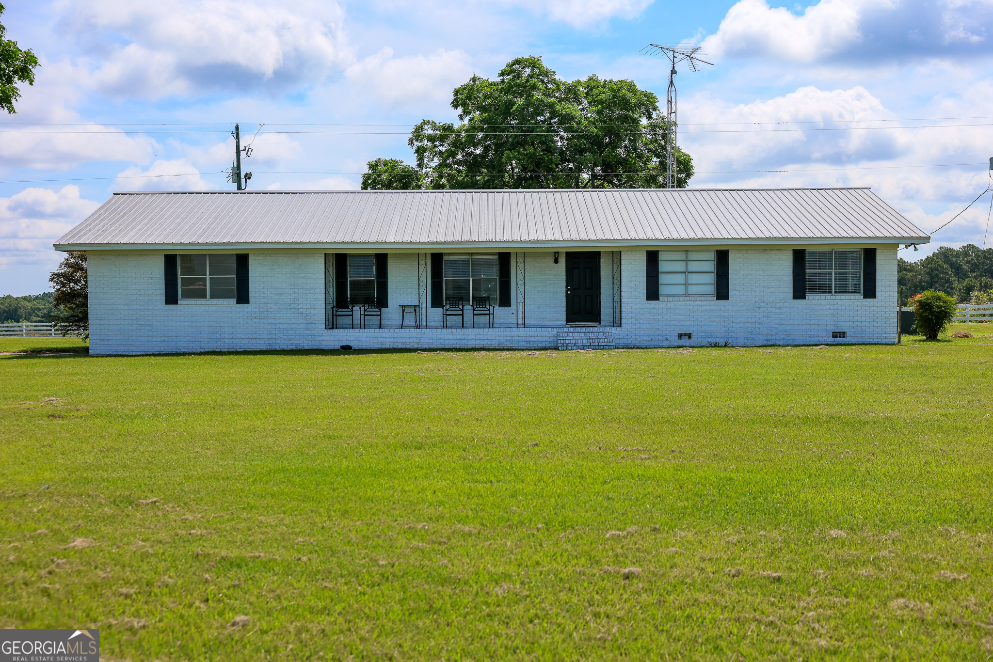 a front view of house with yard and trees