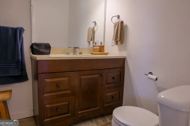 a bathroom with a sink a toilet and mirror