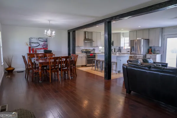 a view of a dining room with furniture and wooden floor