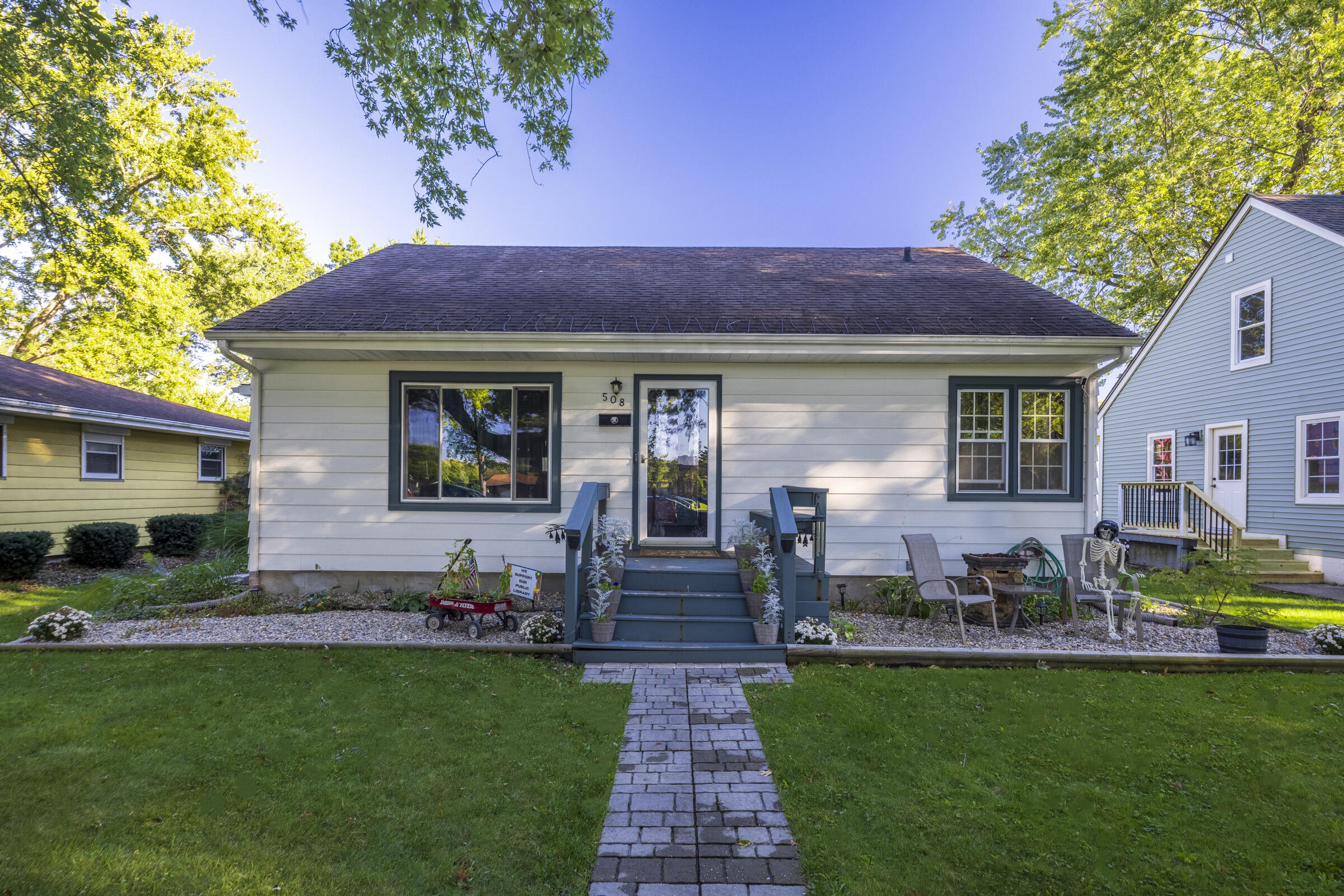 a front view of house with yard and outdoor seating