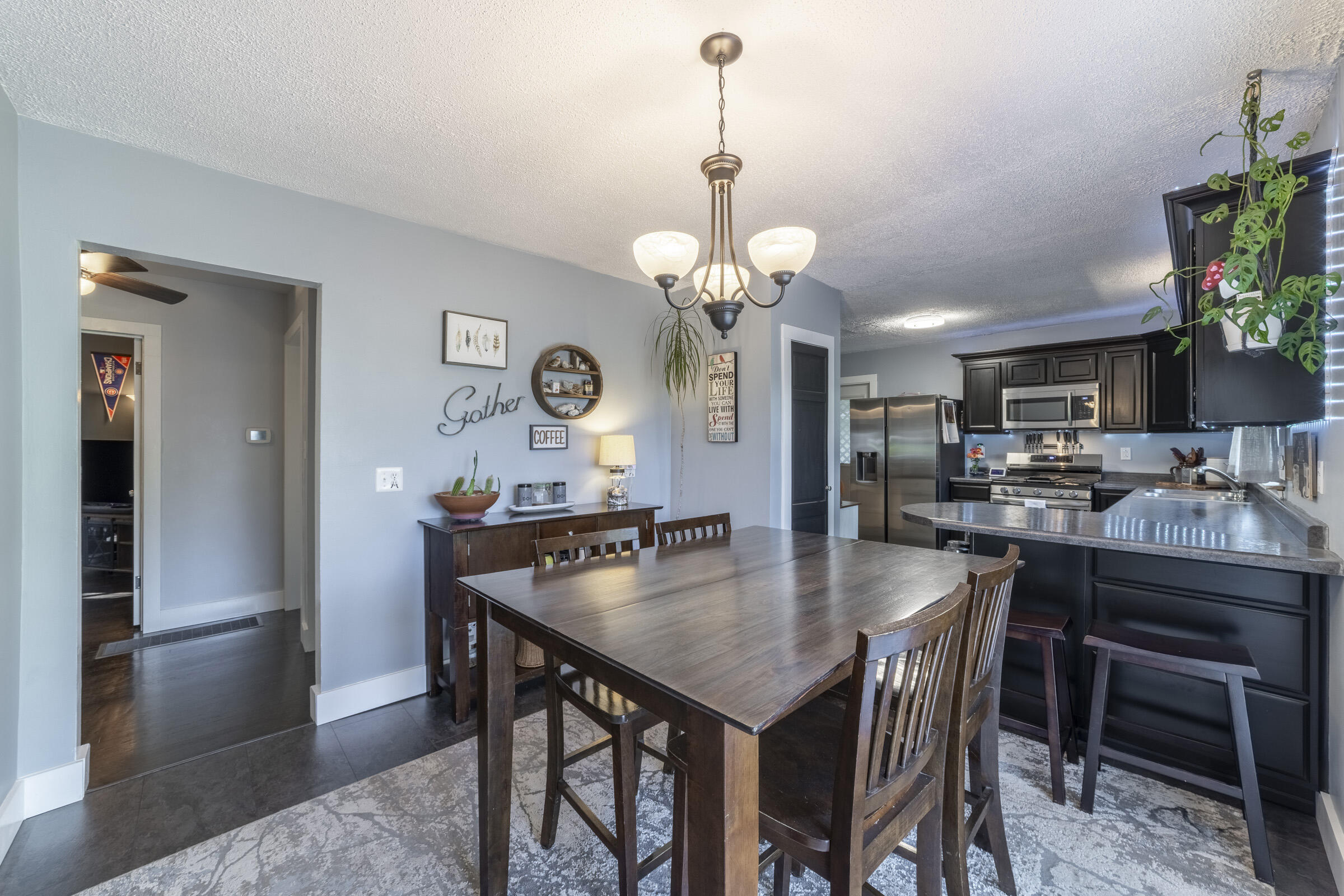508 West Morgan Avenue Chesterton, IN 46304 - Photo 8 of 38 a dining room with wooden floor a chandelier a wooden table and chairs