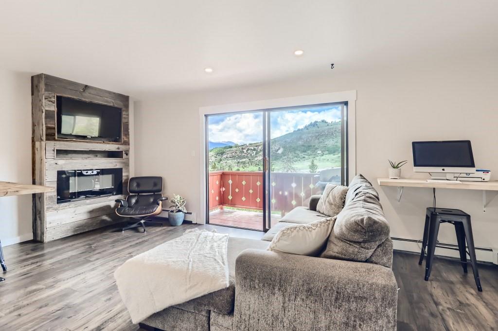 180 Evergreen Road, Unit 204 Dillon, CO 80435 - Photo 1 of 13 a living room with furniture and a flat screen tv