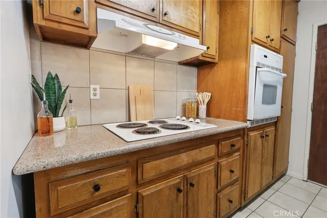 a kitchen with cabinets and stove
