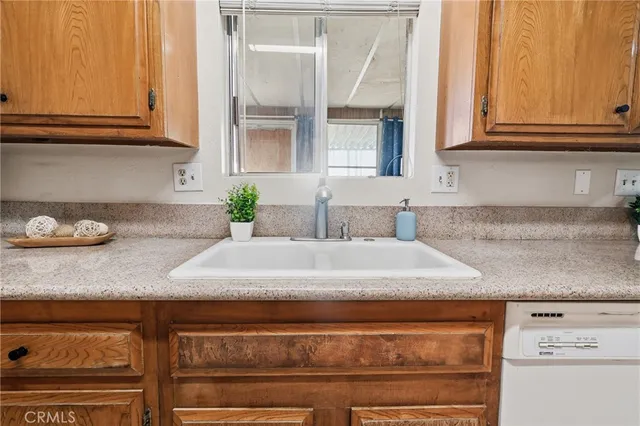 a bathroom with granite countertop a sink and cabinets