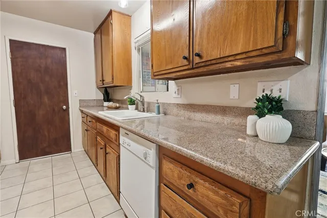 a kitchen with granite countertop a sink and cabinets