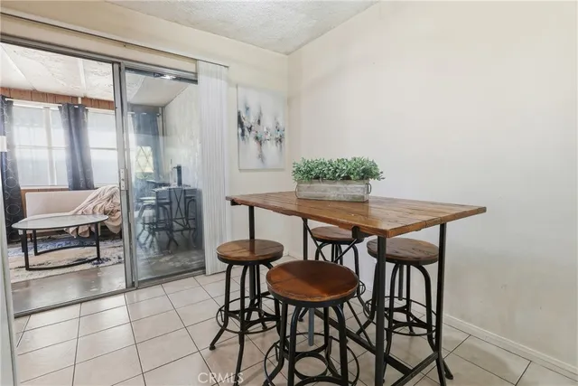 a view of a dining room that has a table and chairs in it