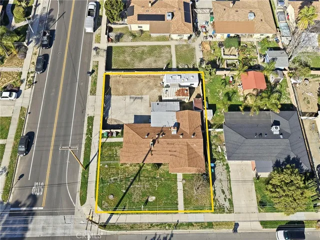 an aerial view of a residential apartment building with a yard
