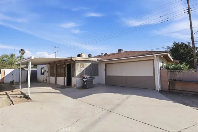 a view of a house with a garage and sitting area