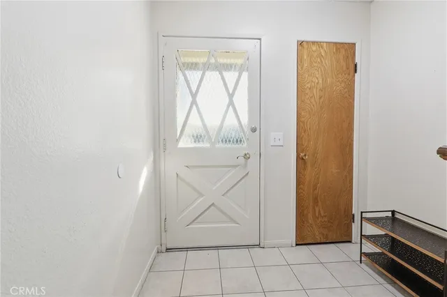 an entryway view with wooden floor and a window