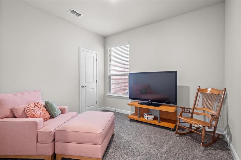 1864 Mensa Drive Haslet, TX 76052 - Photo 31 of 40 a living room with furniture and a flat screen tv