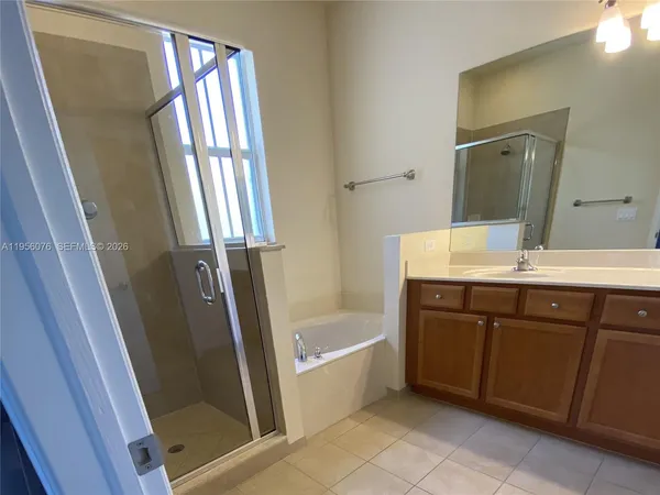 a bathroom with a bathtub a sink a toilet and a mirror