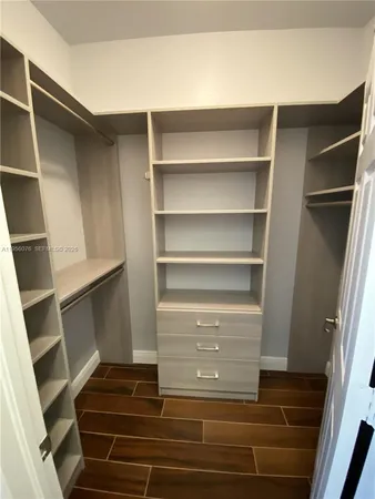 a view of walk in closet with empty racks