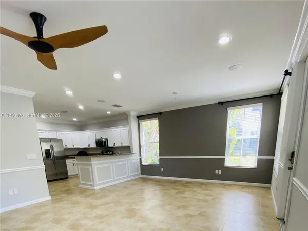 a view of kitchen with refrigerator sink and microwave