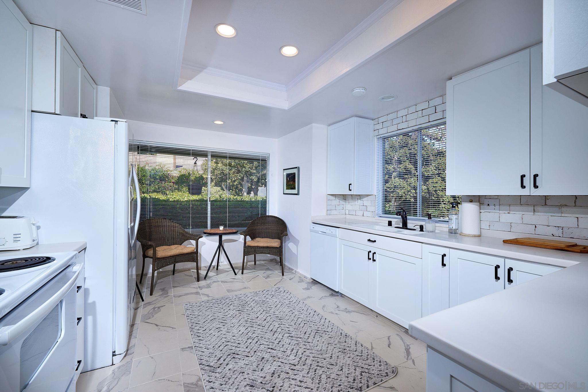 2035 Caminito Circulo Sur La Jolla, CA 92037 - Photo 11 of 22 a dining room with furniture and a potted plant