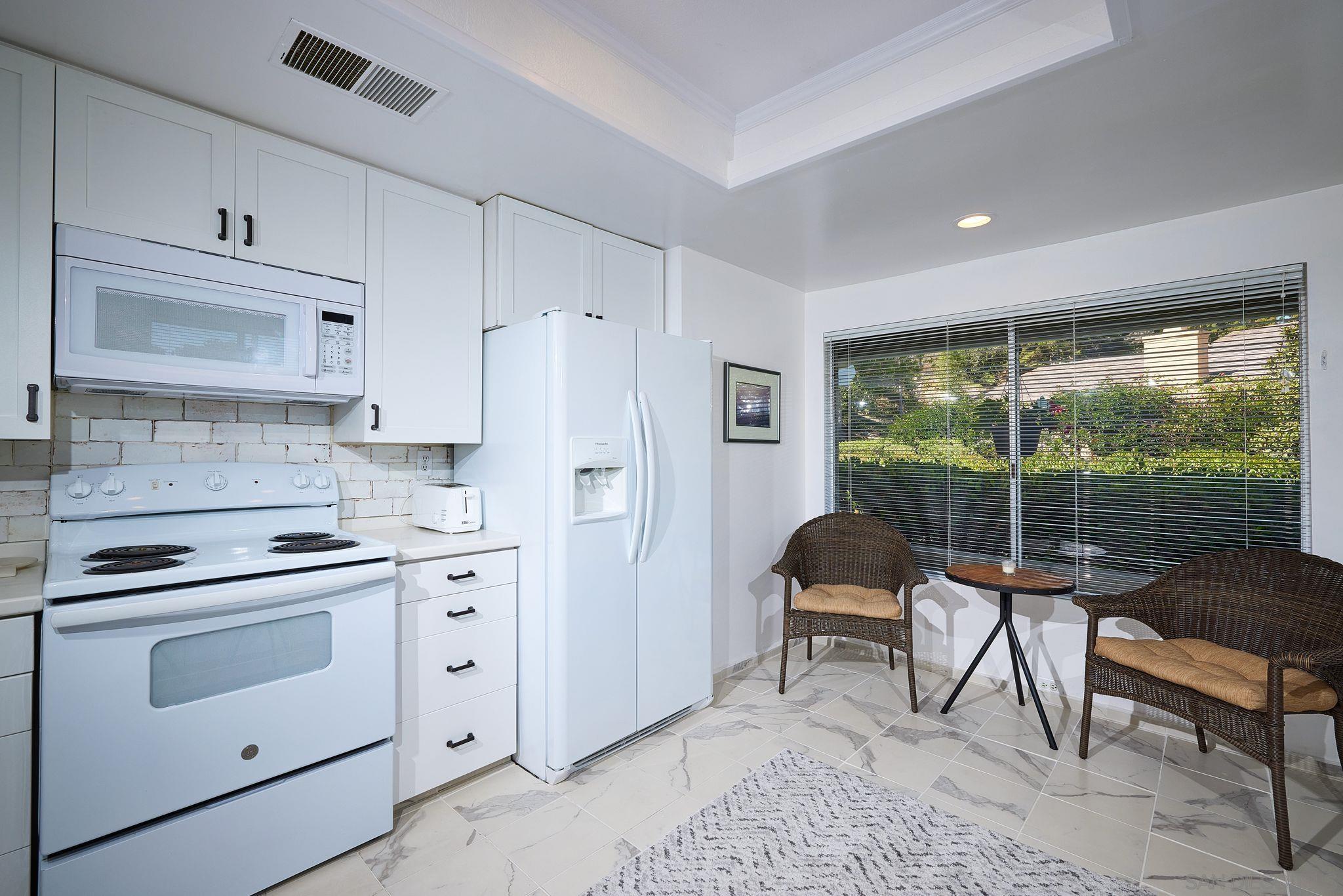 2035 Caminito Circulo Sur La Jolla, CA 92037 - Photo 12 of 22 a view of a dining room with furniture window and wooden floor