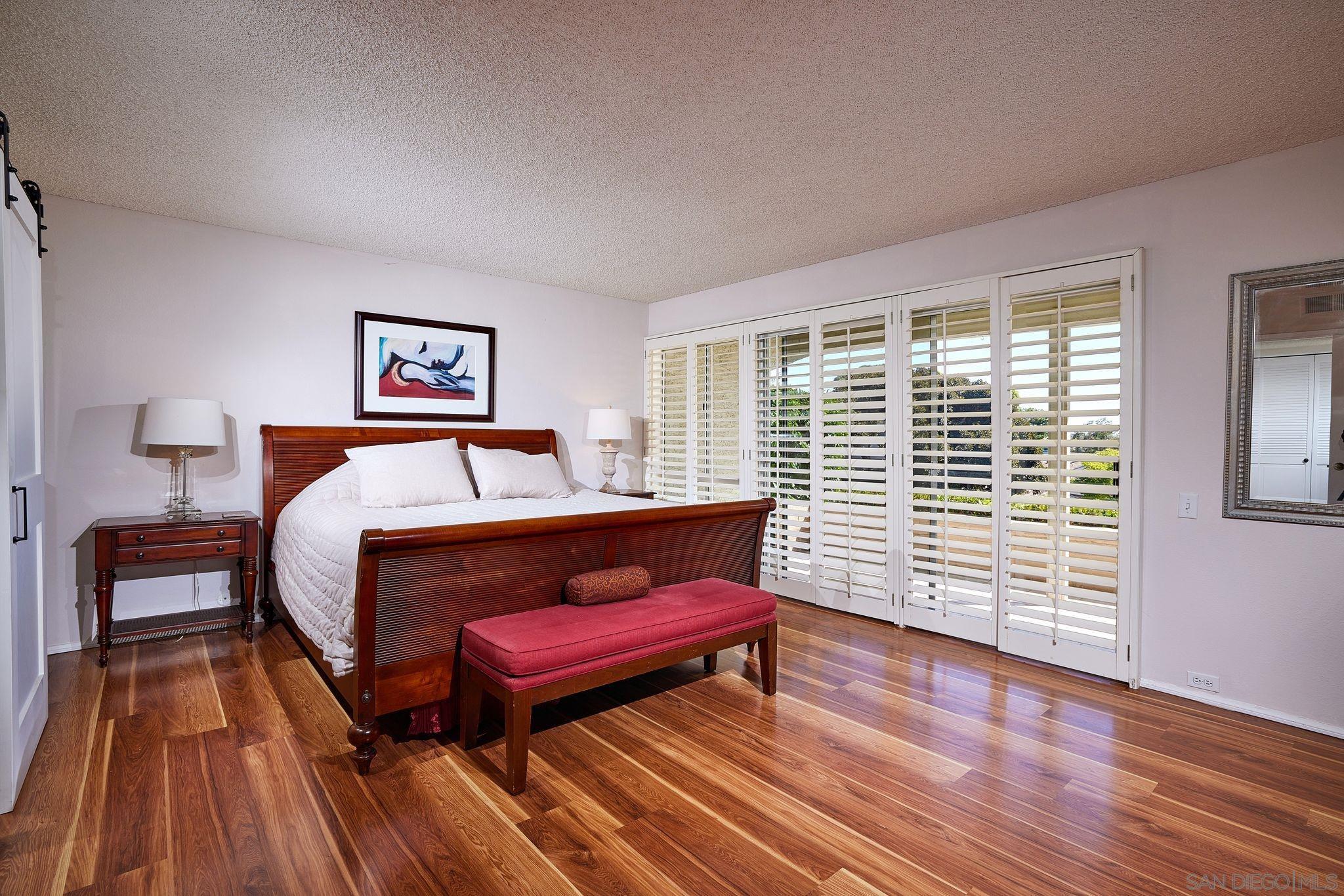 2035 Caminito Circulo Sur La Jolla, CA 92037 - Photo 17 of 22 a bedroom with a bed and a flat screen tv