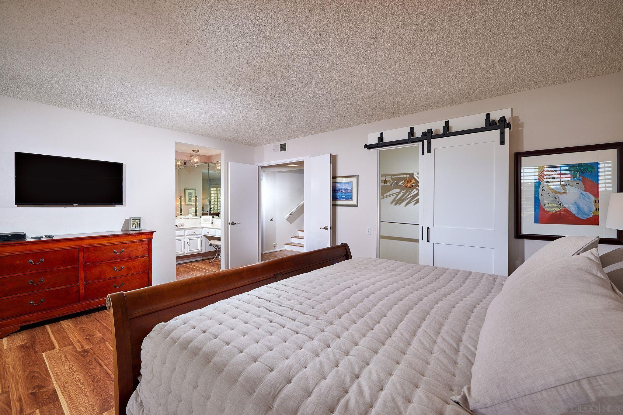 2035 Caminito Circulo Sur La Jolla, CA 92037 - Photo 18 of 22 a bedroom with furniture and a wooden floor