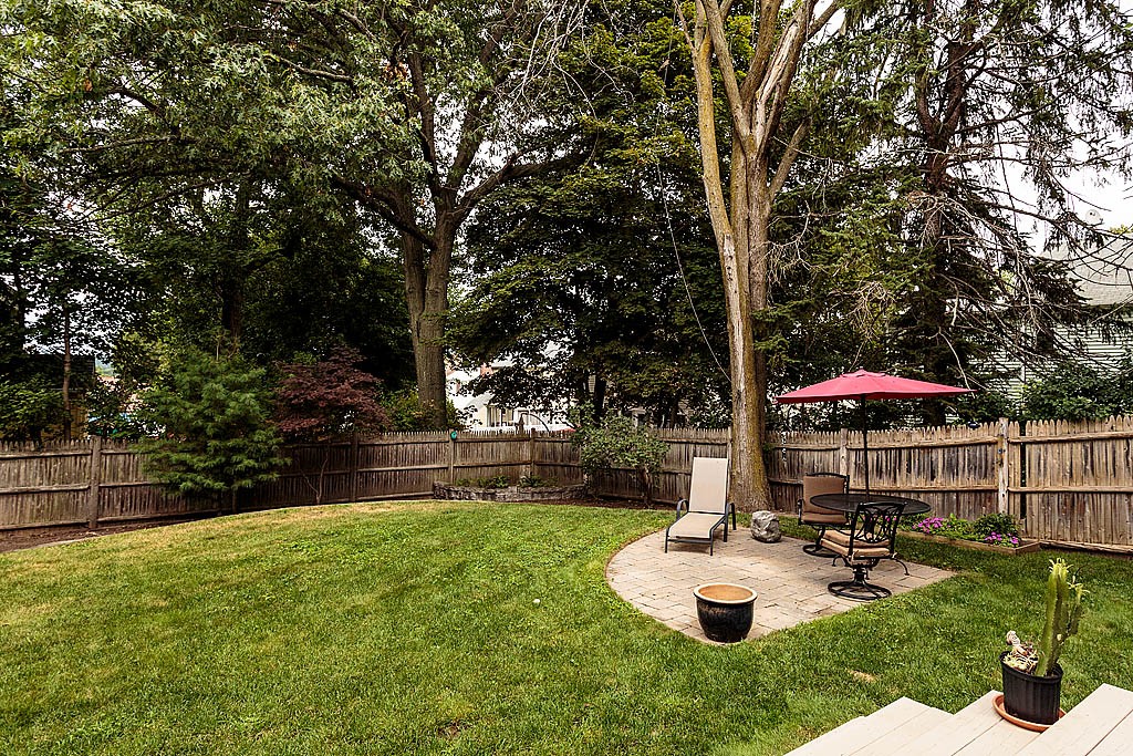60 Watson Road Belmont, MA 02478 - Photo 20 of 21 a view of a patio with a table and chairs under an umbrella