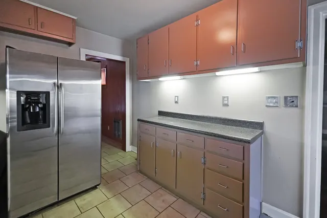 a kitchen with cabinets and stainless steel appliances